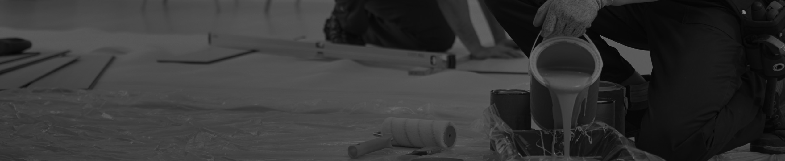 Paint being poured into a bucket.