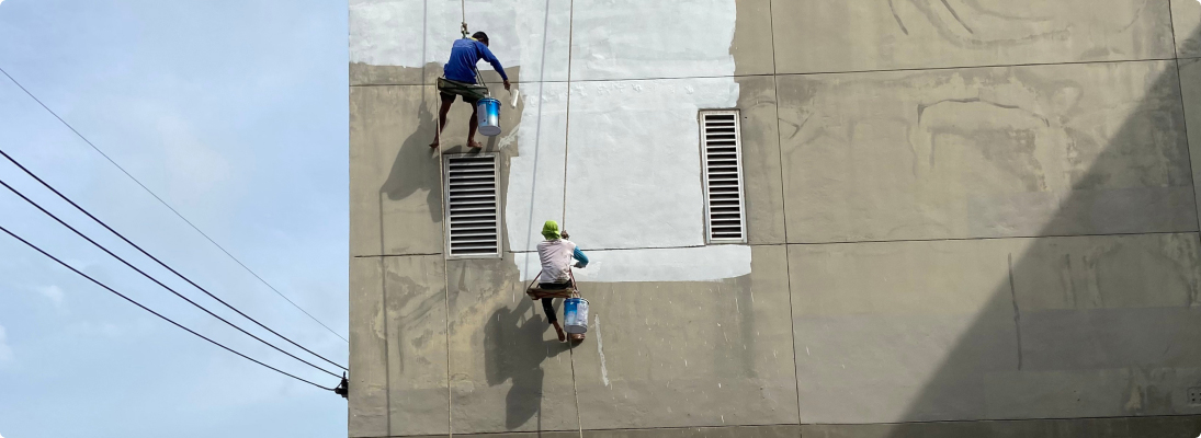 Construction worker assemble a suspended ceiling with drywall and fixing the drywall to the ceiling metal frame with screwdriver. Renovation, construction and ceiling installation concept.