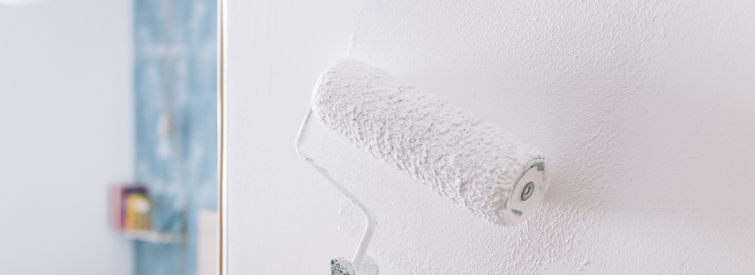 Construction worker assemble a suspended ceiling with drywall and fixing the drywall to the ceiling metal frame with screwdriver. Renovation, construction and ceiling installation concept.