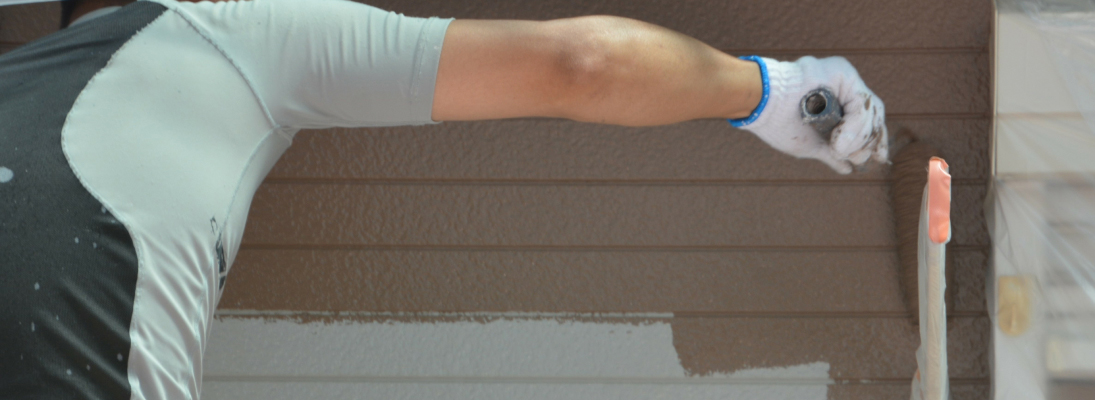 Construction worker assemble a suspended ceiling with drywall and fixing the drywall to the ceiling metal frame with screwdriver. Renovation, construction and ceiling installation concept.