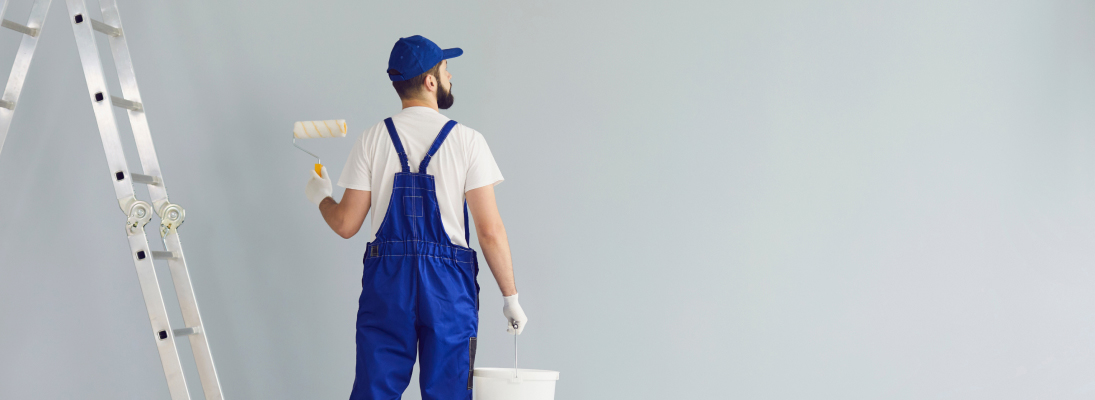 Construction worker assemble a suspended ceiling with drywall and fixing the drywall to the ceiling metal frame with screwdriver. Renovation, construction and ceiling installation concept.