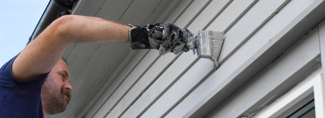 Construction worker assemble a suspended ceiling with drywall and fixing the drywall to the ceiling metal frame with screwdriver. Renovation, construction and ceiling installation concept.