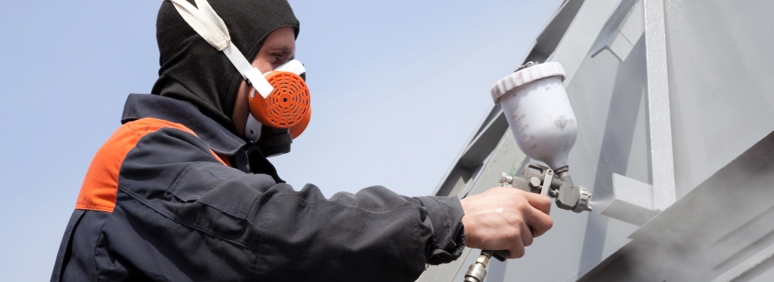 Construction worker assemble a suspended ceiling with drywall and fixing the drywall to the ceiling metal frame with screwdriver. Renovation, construction and ceiling installation concept.