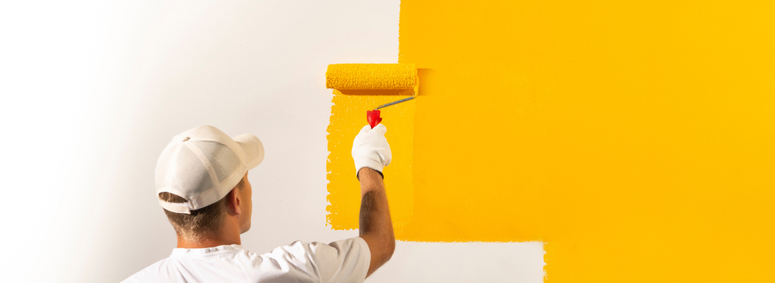 Construction worker assemble a suspended ceiling with drywall and fixing the drywall to the ceiling metal frame with screwdriver. Renovation, construction and ceiling installation concept.