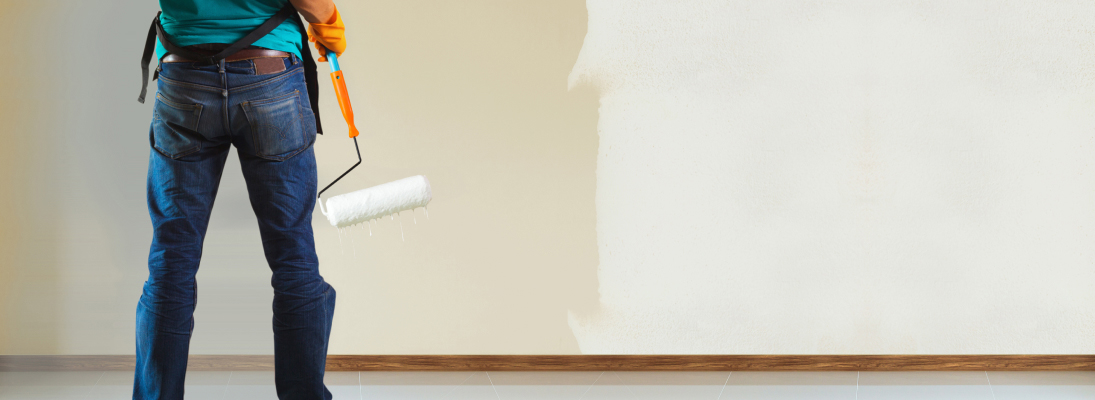 Construction worker assemble a suspended ceiling with drywall and fixing the drywall to the ceiling metal frame with screwdriver. Renovation, construction and ceiling installation concept.