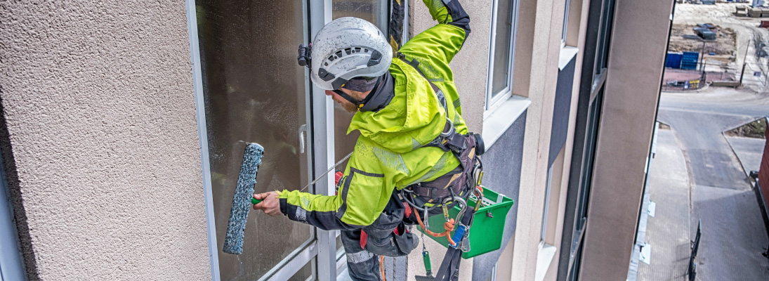 Construction worker assemble a suspended ceiling with drywall and fixing the drywall to the ceiling metal frame with screwdriver. Renovation, construction and ceiling installation concept.