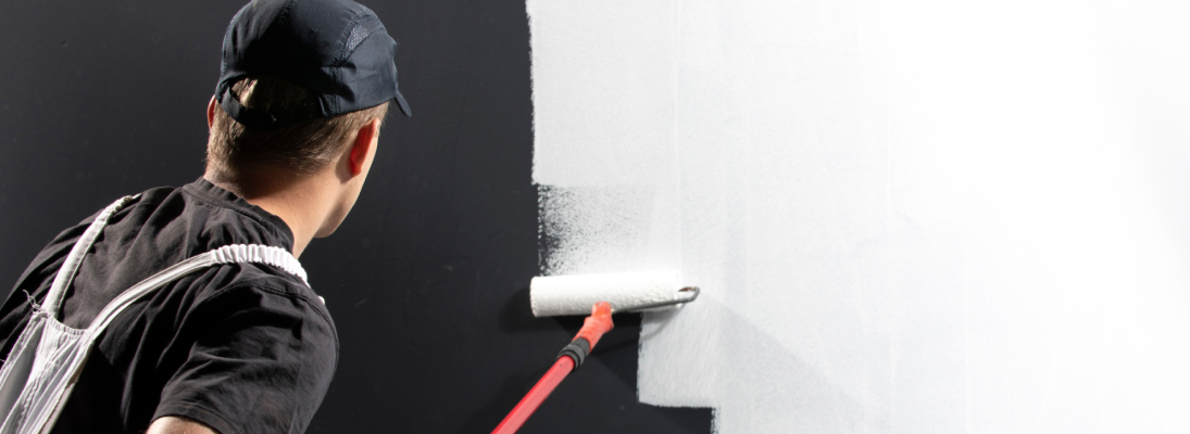 Construction worker assemble a suspended ceiling with drywall and fixing the drywall to the ceiling metal frame with screwdriver. Renovation, construction and ceiling installation concept.