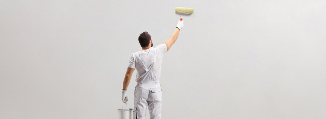 Construction worker assemble a suspended ceiling with drywall and fixing the drywall to the ceiling metal frame with screwdriver. Renovation, construction and ceiling installation concept.