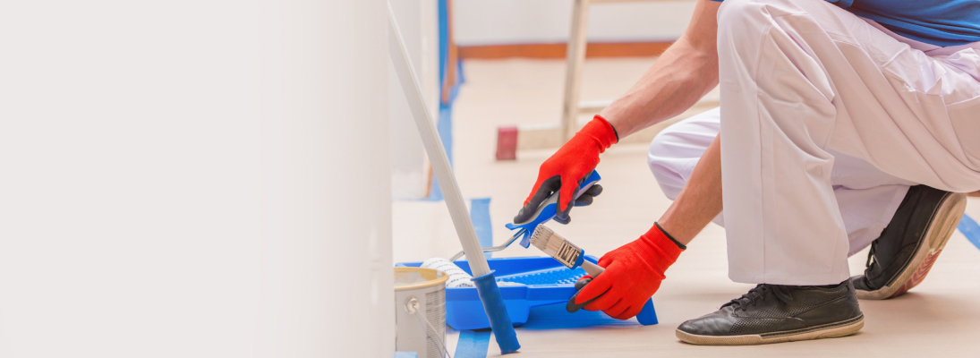 Construction worker assemble a suspended ceiling with drywall and fixing the drywall to the ceiling metal frame with screwdriver. Renovation, construction and ceiling installation concept.