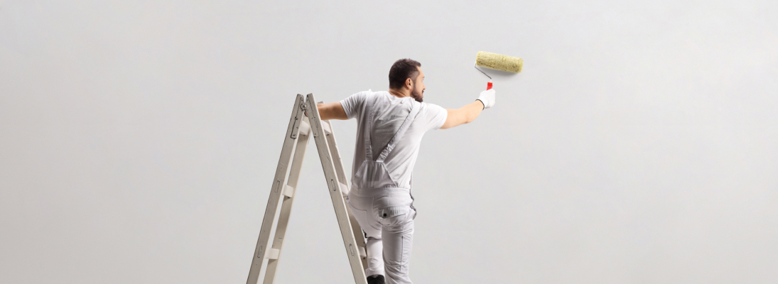 Construction worker assemble a suspended ceiling with drywall and fixing the drywall to the ceiling metal frame with screwdriver. Renovation, construction and ceiling installation concept.