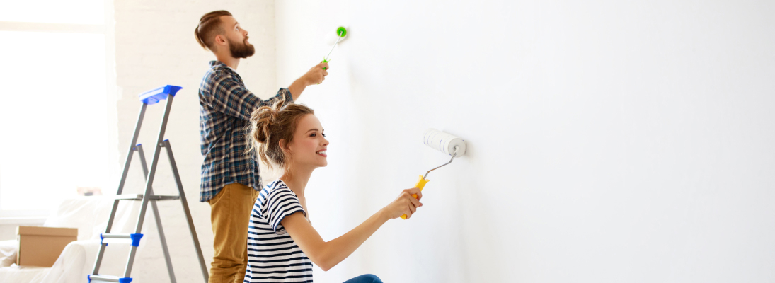 Construction worker assemble a suspended ceiling with drywall and fixing the drywall to the ceiling metal frame with screwdriver. Renovation, construction and ceiling installation concept.