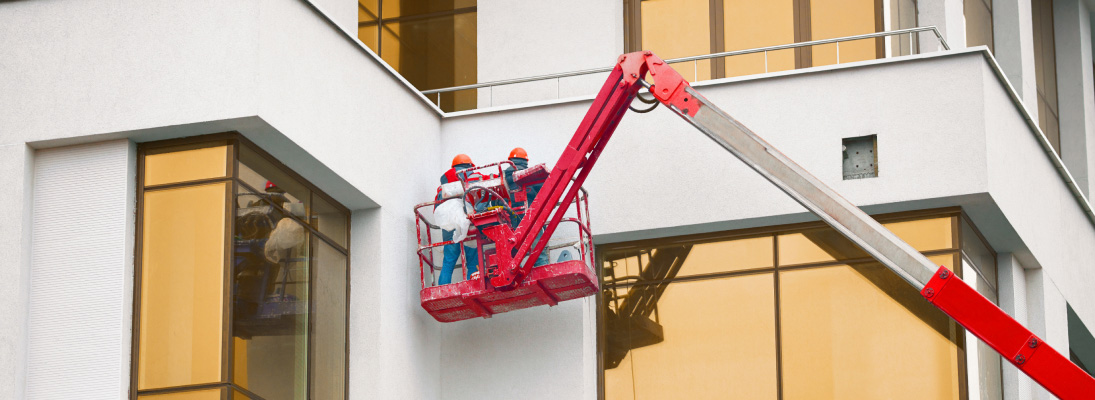 Construction worker assemble a suspended ceiling with drywall and fixing the drywall to the ceiling metal frame with screwdriver. Renovation, construction and ceiling installation concept.