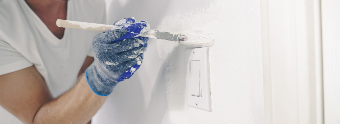 Construction worker assemble a suspended ceiling with drywall and fixing the drywall to the ceiling metal frame with screwdriver. Renovation, construction and ceiling installation concept.