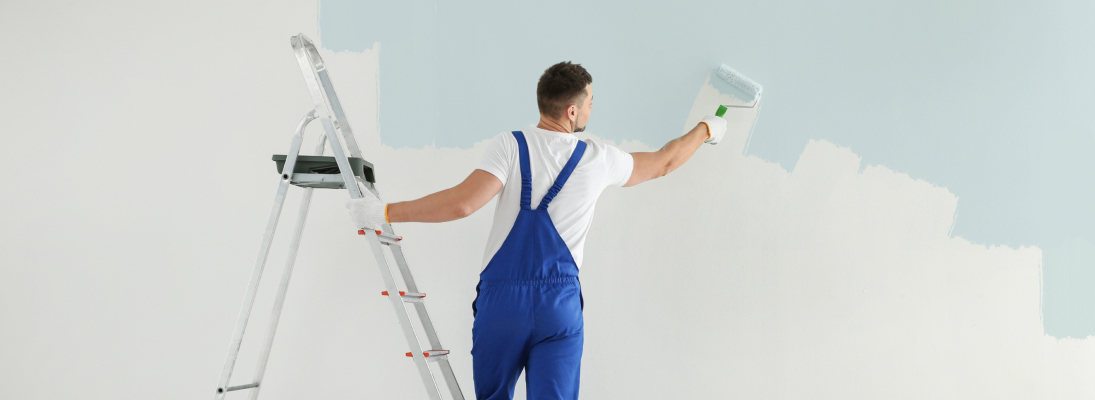 Construction worker assemble a suspended ceiling with drywall and fixing the drywall to the ceiling metal frame with screwdriver. Renovation, construction and ceiling installation concept.