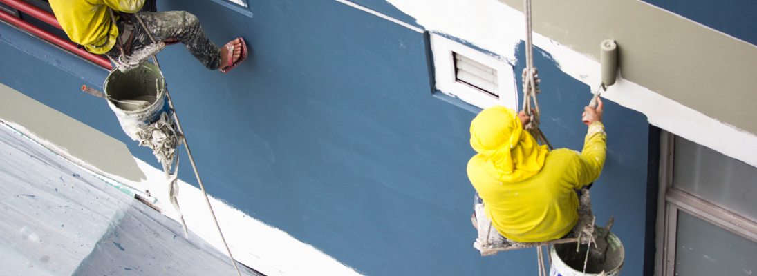 Construction worker assemble a suspended ceiling with drywall and fixing the drywall to the ceiling metal frame with screwdriver. Renovation, construction and ceiling installation concept.