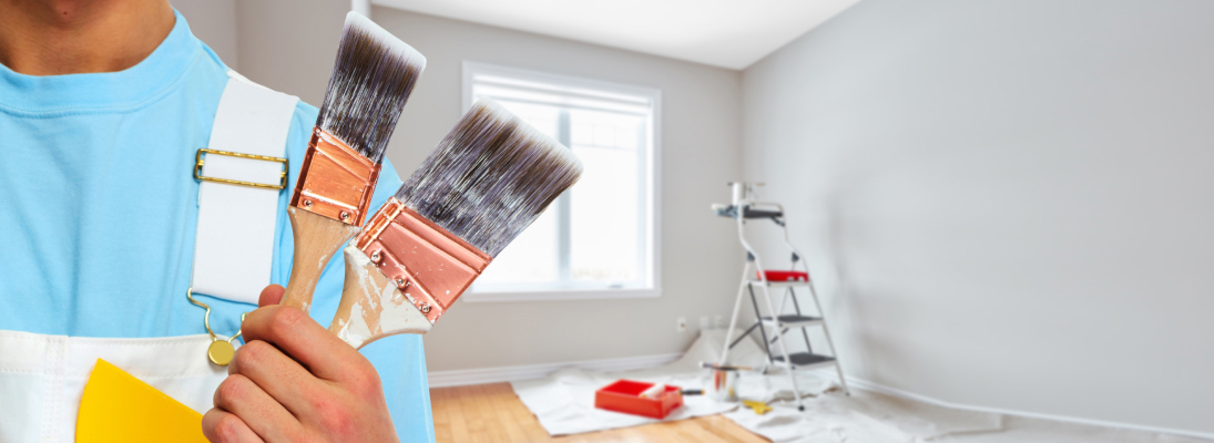 Construction worker assemble a suspended ceiling with drywall and fixing the drywall to the ceiling metal frame with screwdriver. Renovation, construction and ceiling installation concept.