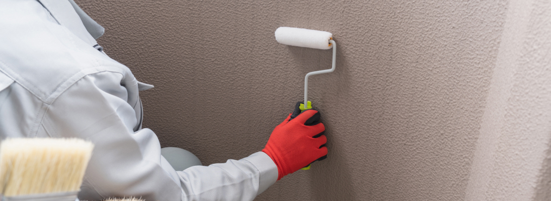 Construction worker assemble a suspended ceiling with drywall and fixing the drywall to the ceiling metal frame with screwdriver. Renovation, construction and ceiling installation concept.