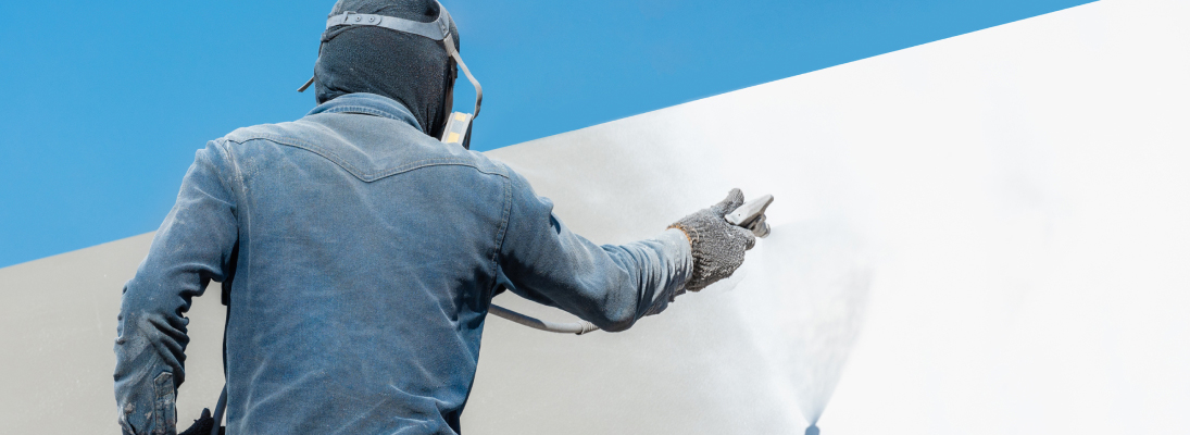 Construction worker assemble a suspended ceiling with drywall and fixing the drywall to the ceiling metal frame with screwdriver. Renovation, construction and ceiling installation concept.