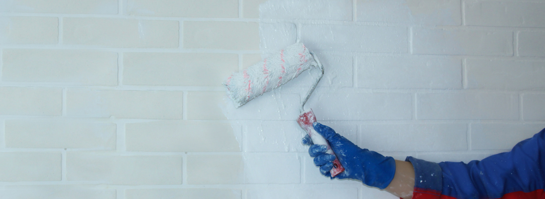 Construction worker assemble a suspended ceiling with drywall and fixing the drywall to the ceiling metal frame with screwdriver. Renovation, construction and ceiling installation concept.