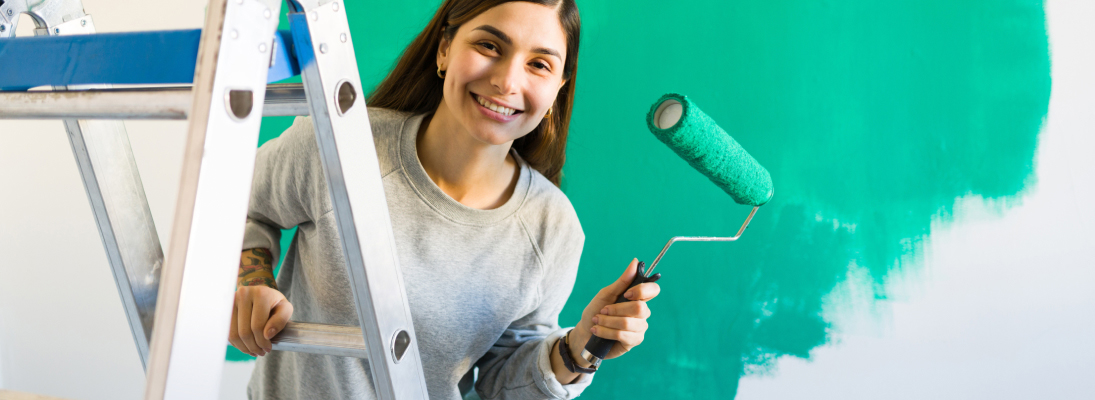 Construction worker assemble a suspended ceiling with drywall and fixing the drywall to the ceiling metal frame with screwdriver. Renovation, construction and ceiling installation concept.