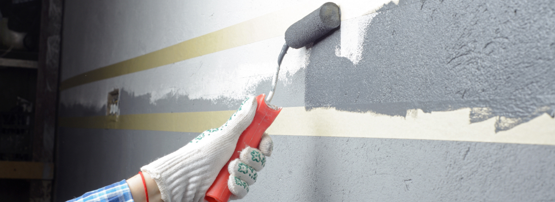 Construction worker assemble a suspended ceiling with drywall and fixing the drywall to the ceiling metal frame with screwdriver. Renovation, construction and ceiling installation concept.